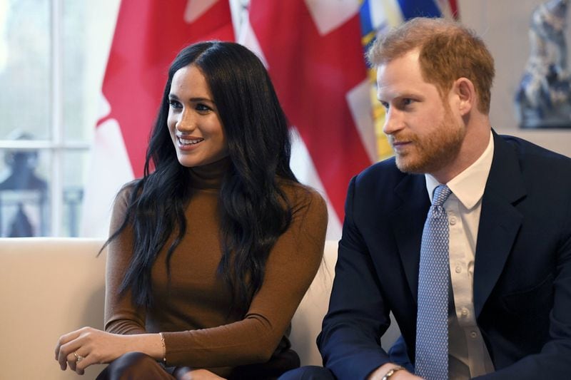 In this Jan. 7, 2020, file photo, Britain’s Prince Harry and Meghan, Duchess of Sussex, smile during their visit to Canada House in London. Prince Harry and his wife, Meghan, are “stepping back” as senior U.K. royals, and they will work to become financially independent, they announced Jan. 8, 2020. DANIEL LEAL-OLIVAS / POOL PHOTO VIA AP, FILE