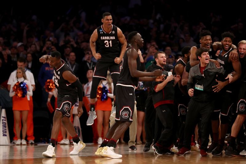 Jarrell Holliman (31) of the South Carolina Gamecocks celebrates with his teammates after defeating the Florida Gators  to win the East Regional at Madison Square Garden on March 26, 2017 in New York City.