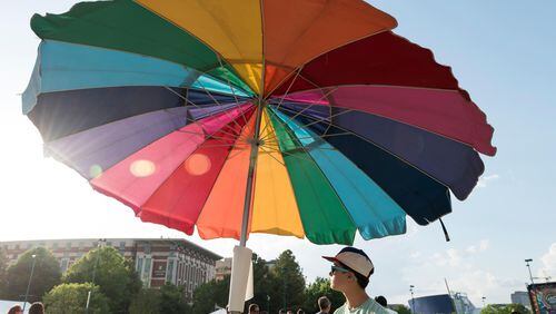 April 21, 2017, Atlanta - The wind blows the King of Pops umbrella while Alison Ortega, bottom right, from Atlanta, Georgia, mans the stand at the SweetWater 420 Fest at Centennial Olympic Park in Atlanta, Georgia, on Friday, April 21, 2017. (DAVID BARNES / DAVID.BARNES@AJC.COM)