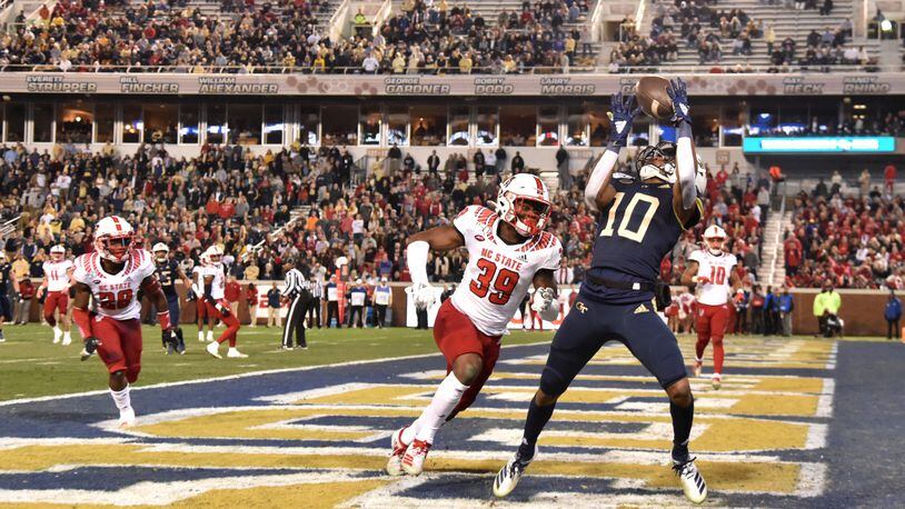Georgia Tech wide receiver Ahmarean Brown (10) makes a touchdown catch over North Carolina State defensive back Jakeen Harris (39) during the first half of an NCAA college football game at Bobby Dodd Stadium on Thursday, November 21, 2019. (Hyosub Shin / Hyosub.Shin@ajc.com)