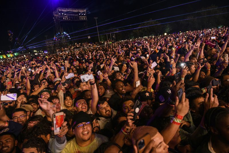 FILE - The crowd watches as Travis Scott performs at Astroworld Festival at NRG park on Friday, Nov. 5, 2021, in Houston. A judge has declined to dismiss hundreds of lawsuits filed against rap star Scott over his role in the deadly 2021 Astroworld festival in which 10 people were killed in a crowd surge. State District Judge Kristen Hawkins issued a one-page order made public Wednesday, April 24, 2024, denying Scott’s request to be dropped from the case. (Jamaal Ellis//Houston Chronicle via AP, File)