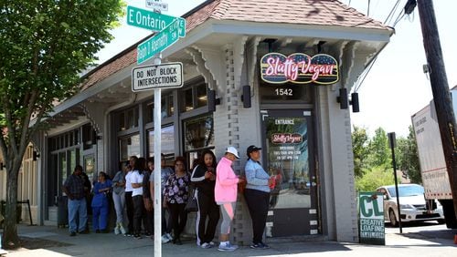 Customers line up outside the Slutty Vegan, which serves naughty-named meatless burgers like the One Night Stand and Menage a Trois. CONTRIBUTED