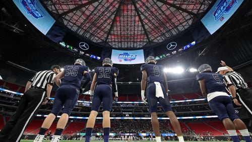 Eagle's Landing Christian captains Zack Jones (56), George Shockley (32), Tre' Douglas (8) and Josh Mays (5) lines up for the coin toss before their game against Athens Academy during the Class A Private Championship at Mercedes-Benz Stadium Friday, December 8, 2017  in Atlanta.