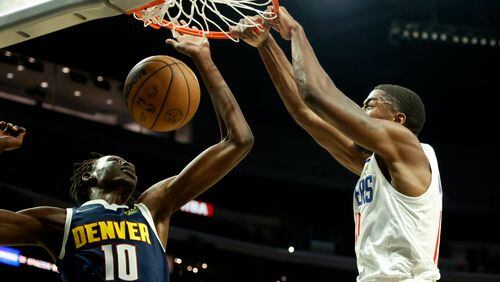 Los Angeles Clippers forward Moses Wright (right) dunks against Denver Nuggets center Bol Bol (10) during the second half of a preseason game Monday, Oct. 4, 2021, in Los Angeles. The Clippers won 103-102. (Ringo H.W. Chiu/AP)