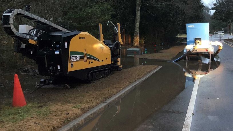 County crews pump water on Columns Drive after a system failure at the South Cobb Water Reclamation Facility in December 2018 caused a massive sewage spill. In 2023, Cobb County is taking legal action against the contractor who the county's lawsuit says is to blame for the system failure. Cobb County