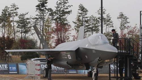 A photographer takes pictures of Lockheed Martin F-35 Lighting II during a media day of Seoul International Aerospace and Defense Exhibition (ADEX) 2013 in Goyang, South Korea, Monday, Oct. 28, 2013. About 360 defense firms from 28 countries participate in the biennial international aerospace and defense exhibition from Oct. 29 to Nov. 3. (AP Photo/Ahn Young-joon)