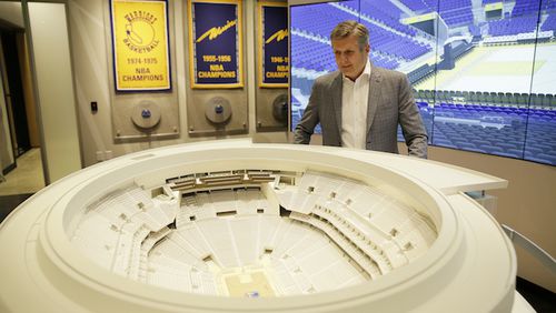 In this photo taken Jan. 24, 2018, Golden State Warriors President and COO Rick Welts looks over a model of Chase Center at the Chase Center Experience in San Francisco. Welts, who turned 65 in January and is the first openly gay NBA executive, can lean not only on the time with the Seattle SuperSonics but also his experience in the league office and with Phoenix to see what things work and don't work when it comes to operating a franchise, to building an arena. (AP Photo/Eric Risberg)