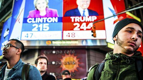 People watch election results at Times Square in New York. Now, businesses, economists and consumers will be watching to see if his promises to spur growth pan out. (George Etheredge/The New York Times)