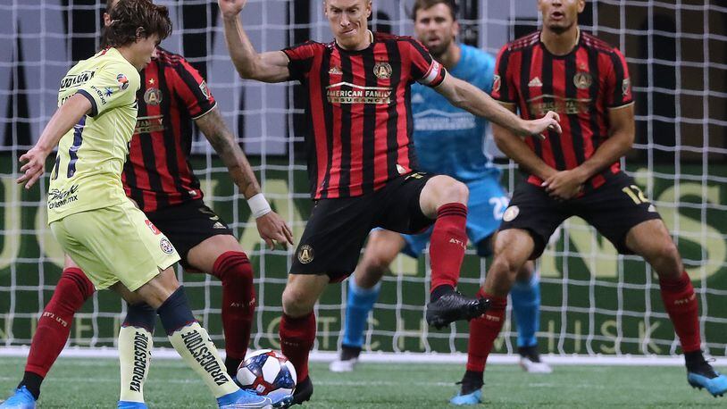 August 14, 2019 Atlanta: Atlanta United captain Jeff Larentowicz (center) and MIles Robinson (right) defend the goal against Club America midfielder Sebastian Cordova in the Campeones Cup on Wednesday, August 14, 2019, in Atlanta.   Curtis Compton/ccompton@ajc.com
