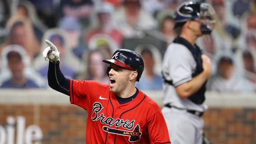 N.Y. Yankees with catcher Erik Kratz (background) looks on as Braves first baseman Freddie Freeman celebrates hitting a two-run homer during the sixth inning of the second game of a double header Wednesday, Aug. 26, 2020, at Truist Park in Atlanta. Freeman's shot proved to be the game winner of 2-1 victory as Atlanta swept the Yankees. (Curtis Compton ccompton@ajc.com)