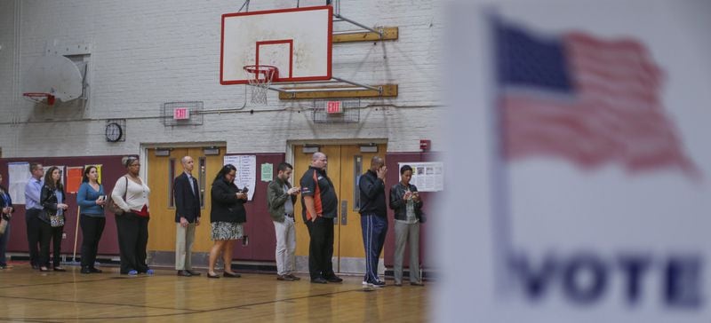 Voters line up to cast ballots at Henry W. Grady High School in Atlanta for Georgia’s presidential primary in 2016. The state’s primary for 2020 will not be scheduled until new voting machines are put in place. JOHN SPINK / JSPINK@AJC.COM