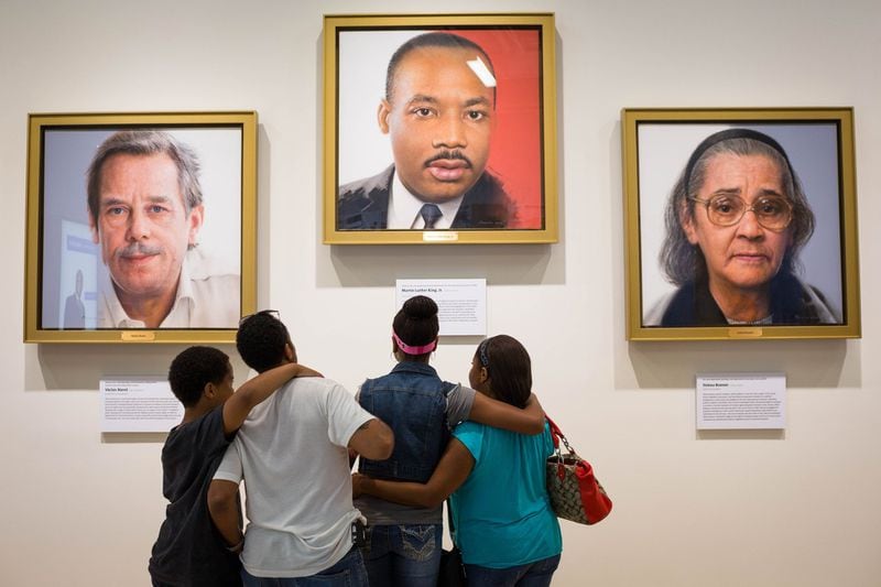 Visitors to the National Center for Civil and Human Rights look at a portrait of Martin Luther King Jr. Because of the coronavirus pandemic, the center and several other civil rights sights have closed. CONTRIBUTED: NATIONAL CENTER FOR CIVIL AND HUMAN RIGHTS