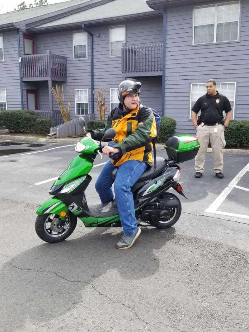Anthony Jones sits on his new scooter purchased by the Acworth Police Department.