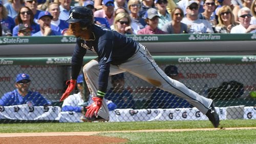 Braves’ Ozzie Albies scores during the first inning against the Chicago Cubs on Sunday, Sept. 3, 2017, in Chicago. (AP Photo/Matt Marton)