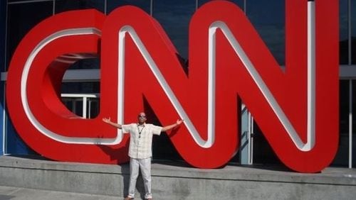 Omar Butcher poses in front of the CNN building in Atlanta on his first day at the network as an associate producer. Butcher, who said he dreamed of working at the network while growing up, was fired after complaining about racially insensitive comments by a popular anchor. (Photo: Contributed)