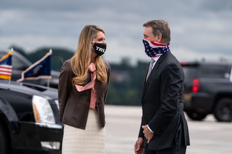 FILE - Sens. Kelly Loeffler (R-Ga.) and David Perdue (R-Ga.) wait to greet President Donald Trump as he exits Air Force One in Atlanta, Sept. 25, 2020. Trump and Democratic presidential nominee Joe Biden remain locked in a tight race in Georgia, and the state’s two Senate seats, which are both up for grabs, are competitive, according to a poll of state voters released Friday. (Anna Moneymaker/The New York Times)