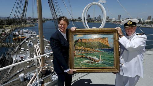 Duncan Sandys, left, great grandson of Sir Winston Churchill, and Commodore Everett Hoard hold up a painting done by Sir Winston Churchill, titled, Coast Scene Near Marseilles, 1930’s, an oil on canvas, that will be on exhibit at an art gallery aboard the Queen Mary in Long Beach, Calif. A total of 10 paintings done by Churchill will be included in the exhibit, which runs from May 27, 2016 to December 31, 2016. (Mel Melcon/Los Angeles Times/TNS)