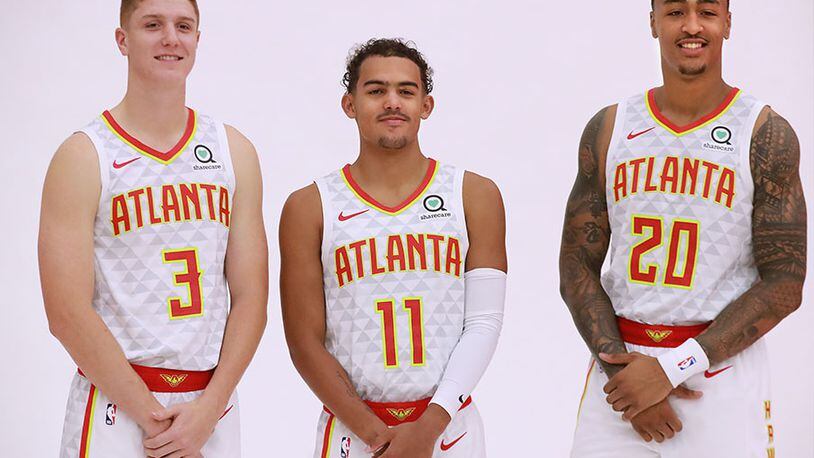 Hawks team core members Kevin Huerter (from left), Trae Young and John Collins pose for a team portrait during media day Monday, Sept. 30, 2019, at the Hawks training facility, the Emory Sports Medicine Complex, in Atlanta.