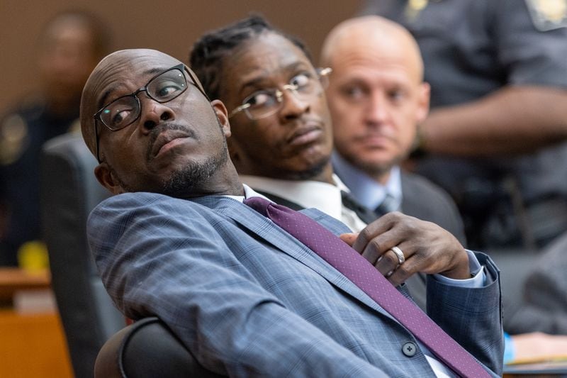 Keith Adams (left), an attorney for Young Thug (center), sits with his client during a hearing in the YSL case on Thursday, December 22, 2022.   (Arvin Temkar / arvin.temkar@ajc.com)