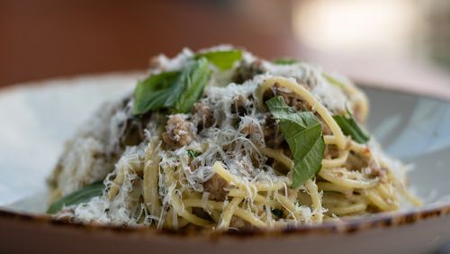 Spaghetti with white Bolognese is topped with torn basil at Donetto in West Midtown. CONTRIBUTED BY HENRI HOLLIS