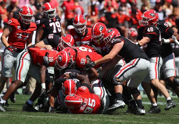 Georgia defenders smother running back Brandon Mathis after  a short gain during the G-Day game on Saturday, April 13, 2024.  Curtis Compton for the Atlanta Journal Constitution