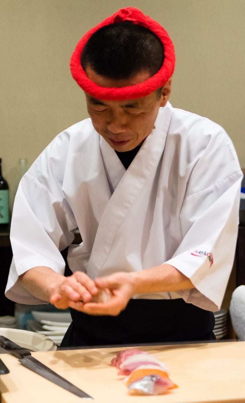Chef Art Hayakawa deftly molds individual pieces of nigiri, some of which hide additional flavorings like wasabi. CONTRIBUTED BY HENRI HOLLIS