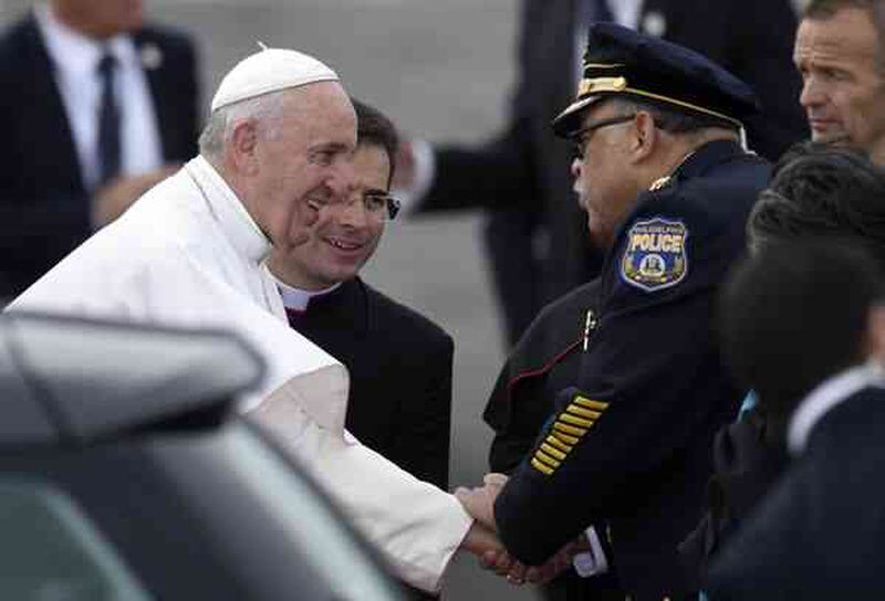 Pope Francis is greeted by Philadelphia Police Commissioner Charles Ramsey as he arrives at Philadelphia International Airport on Saturday. AP Photo/Susan Walsh