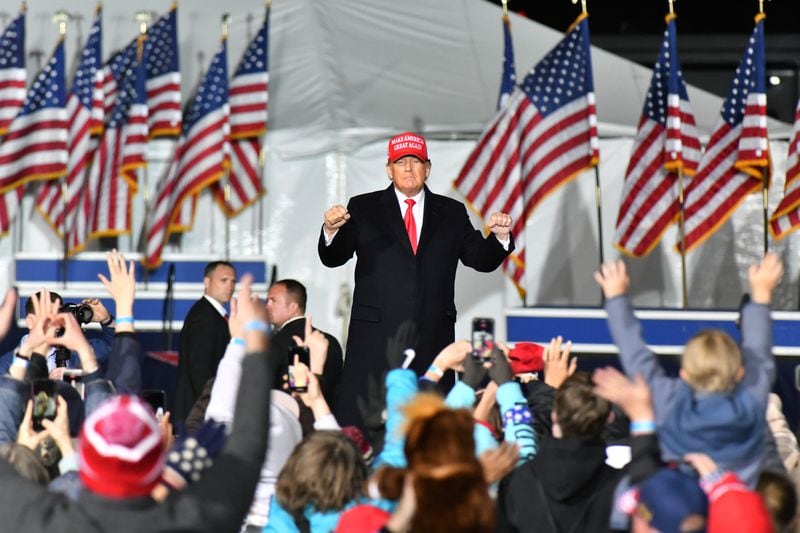 Former President Donald Trump dances as he leaves the stage during a rally for Georgia GOP candidates at Banks County Dragway in Commerce on Saturday, March 26, 2022. (Hyosub Shin / Hyosub.Shin@ajc.com)