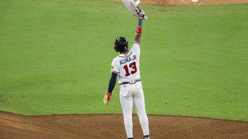 Atlanta Braves’ Ronald Acuna Jr. (13) holds up second base after he stole his 70th base of the season during the 10th inning against the Chicago Cubs at Truist Park, Wednesday, September 27, 2023, in Atlanta. (Jason Getz / Jason.Getz@ajc.com)