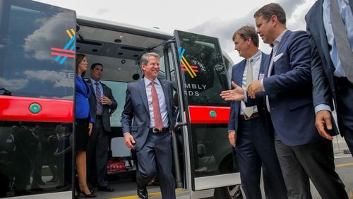 Gov. Brian Kemp disembarks from a ride on a driver-less shuttle in Doraville. Alyssa Pointer/AJC