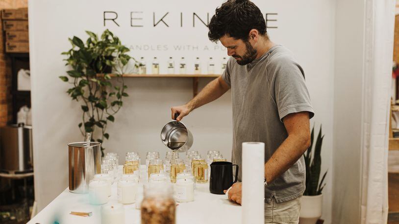With so many people spending more time in their homes, the urge for comforting ambience has boosted the demand for scented candles. Here, Matt Mewbourne, owner of Rekindle Candle Co. in Monroe, pours candle wax, a mixture of soy wax and coconut oil that hardens overnight to produce a batch of candles.