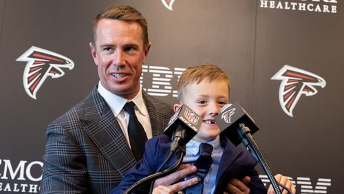 Former Falcons quarterback Matt Ryan brings his son to the microphone after announcing his retirement at a press conference at the Falcons practice facility in Flowery Branch on Monday, April 22, 2024. (Arvin Temkar / arvin.temkar@ajc.com)