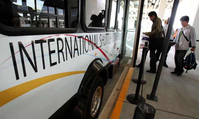 Passengers load onto a shuttle bus on their way to the domestic terminal at the Maynard H. Jackson Jr. International Terminal at Hartsfield-Jackson International Airport Thursday afternoon in Atlanta, Ga., May 24, 2012. Atlanta's new international terminal has been open just over a week, and some returning travelers are steamed waiting an hour in some cases to catch overwhelmed shuttle buses back to their parked cars or MARTA.  Jason Getz / Jason.Getz@ajc.com