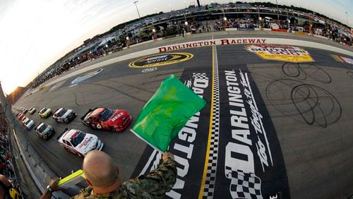 In this May 11, 2012, file photo, drivers take the green flag for the start of the NASCAR Nationwide Series auto race at Darlington Raceway in Darlington, S.C. NASCAR will re-fire the engines moments after mask-clad drivers climb into their cars at Darlington Raceway. The season will resume Sunday May 17, 2020, without spectators and drivers will have no practice before they pull away from pit road for the first time in more than two months. (Tyler Barrick/Pool Photo via AP, File)