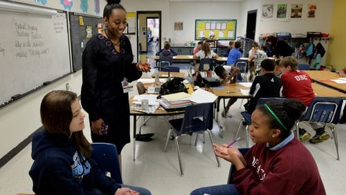 April 21, 2015 Sandy Springs, GA: Patrice Dawkins-Jackson helps gifted 5th grade students Jordana Andrade and Meah Poret at Dunwoody Springs Elementary. After years of budget cuts, teachers in Georgia are expected to receive significant raises next school year. BRANT SANDERLIN/BSANDERLIN@AJC.COM