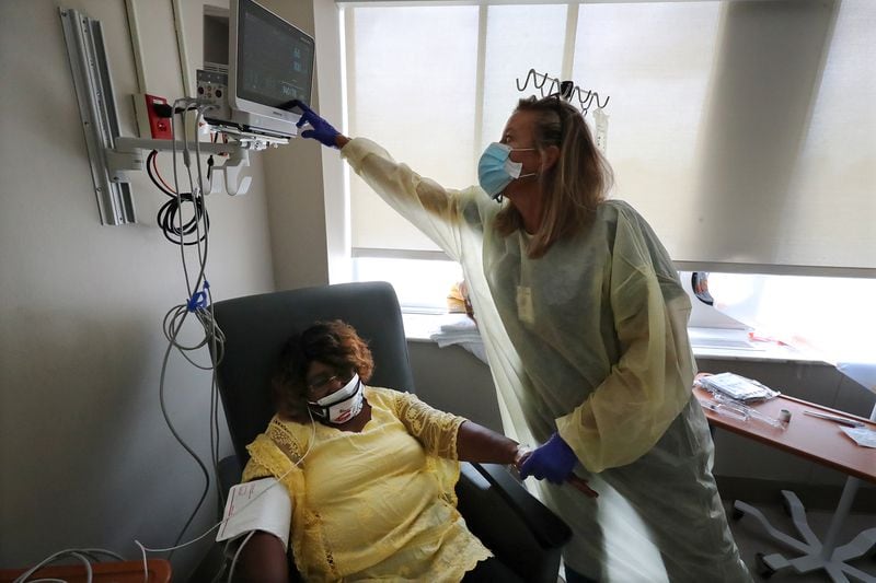 Julie Fox, registered, administers monoclonal antibody infusion therapy to patient Mary Smith in one of the infusion rooms at Phoebe Putney Memorial Hospital (North Campus). Curtis Compton/Curtis.Compton@ajc.com”