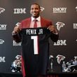 First-round selection quarterback Michael Penix Jr. poses for a photo with her jersey during the Atlanta Falcons introductory press conference at the Falcons Headquarters in Flowery Branch on Friday, April 26, 2024. (Natrice Miller/ AJC)
