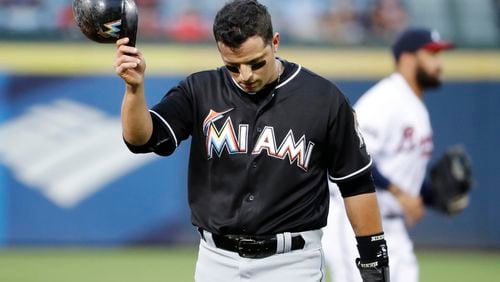 Miami Marlins' Martin Prado walks to the dugout after the first inning in which he hit a single to score teammate Dee Gordon in a baseball game against the Atlanta Braves in Atlanta, Wednesday, Sept. 14, 2016. (AP Photo/David Goldman)