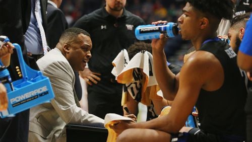 Ron Hunter talks with his team during a timeout om Friday's game. Frederick Breedon/Getty Images)