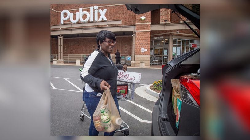 An Instacart shopper loads her car after picking up groceries from Publix for her clients Sunday, March 29, 2020.   She said needs the work and was not going to join a possible strike. (Photo: STEVE SCHAEFER / SPECIAL TO THE AJC)