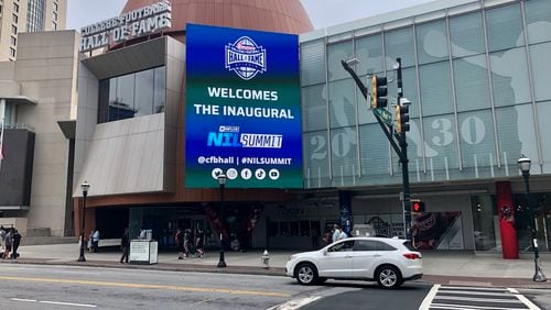 A marquee outside the College Football Hall of Fame in downtown Atlanta welcomes the first NIL Summit, held at the hall June 13-15. (AJC photo by Ken Sugiura)