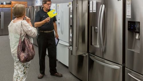 Gail Peterson, Boynton Beach, looks at refrigerators Wednesday with sales counselor Walter Fron at Rosner’s Appliance in West Palm Beach. “My fridge is dying,” Peterson said. Fron explained the upcoming Florida state sales tax rebate on Energy Star appliances during her visit to the store.