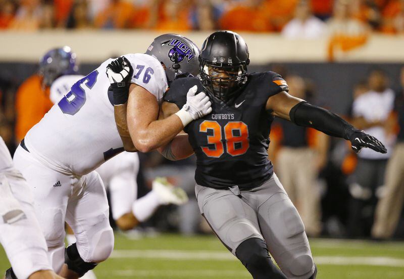 Oklahoma State defensive end Emmanuel Ogbah (38) attempts to move around Central Arkansas Kyle Stouffer (76) during an NCAA college football game between Central Arkansas and Oklahoma St in Stillwater, Okla., Saturday, Sept. 12, 2015. (AP Photo/Sue Ogrocki)