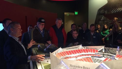 Mercedes-Benz USA CEO Steve Cannon, left, shows off the model of Mercedes-Benz Stadium to automotive journalists at the Atlanta Falcons ticket sales preview center in Buckhead. Wednesday, October 28, 2015. J. Scott Trubey/Staff strubey@ajc.com