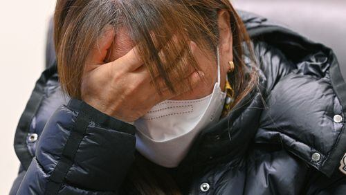 Hyun Jung Kim, 48, daughter of one of the Atlanta spas' shooting victims, Soon Chung Park, cries as she and her younger sister Hyo Jung Kim, 46, recall their late mother. Soon Chung Park was among eight people shot and killed March 16 at three spas, two in Atlanta and one in Cherokee County. Park was one of six victims of Asian heritage. (Hyosub Shin / Hyosub.Shin@ajc.com)