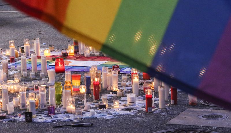 SECONDARY PHOTO - June 13, 2016 Atlanta: Candles remained burning brightly Monday morning, June 13, 2016 in the parking lot of Ten Atlanta at 990 Piedmont Ave NE, Atlanta after an overnight vigil remembering the Orlando mass shooting victims. On Sunday night at the corner of 10th Street and Piedmont Avenue in Atlanta, crowds spilled onto 10th Street and the road was closed to traffic as people remembered those injured and killed in the mass shooting at an Orlando gay club early that morning. Atlanta Mayor Kasim Reed, told residents the city had stepped up its own protections, but said he was there because it was important for him to show his support of the city's gay community The Atlanta Police Department estimated 1,000 people gathered outside of Ten, at the same corner many celebrated a Supreme Court victory last summer that made same-sex marriage legal. On Sunday, after a moment of silence, they sang "The Star-Spangled Banner," holding candles aloft. The Atlanta Freedom Bands played the hymn "Salvation is Created." JOHN SPINK /JSPINK@AJC.COM