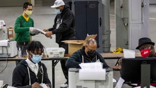 Fulton County elections workers sort and count absentee ballots during the county's second recount of presidential election ballots at the Georgia World Congress Center, Tuesday, Nov. 25, 2020. (Alyssa Pointer / Alyssa.Pointer@ajc.com)
