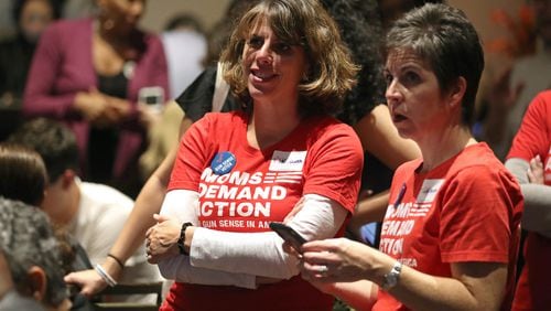 Beth Freeman, center, of Marietta, and Amy Jeffs, of Roswell, both with Moms Demand Action, watch election returns during the Lucy McBath watch party in Sandy Springs last week. McBath defeated Republican incumbent Karen Handel in the Sixth District congressional contest. JASON GETZ/SPECIAL TO THE AJC