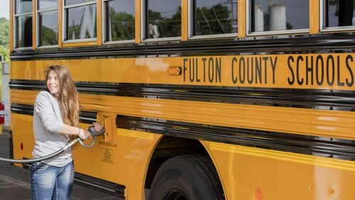 Julie Alighieri, a Fulton County school bus driver, fuels up at a propane filling station at the school district bus yard in Alpharetta.