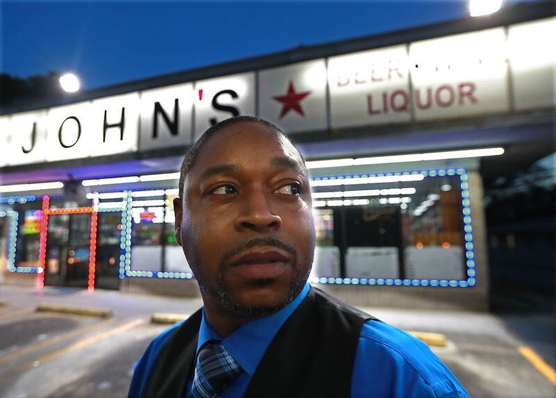 Erick Ferguson, a witness in a New Year’s Eve officer-involved shooting, discusses how close he came to being hit by the bullets during an interview Monday at Big John's Package Store in Stone Mountain, where the incident occurred. CURTIS COMPTON / CCOMPTON@AJC.COM